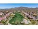 Aerial view of lush green golf course nestled among desert homes and mountains at 42047 N Moss Springs Rd, Anthem, AZ 85086