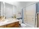 Well-lit bathroom with a single sink vanity, a shower-tub combo, and a large mirror at 42047 N Moss Springs Rd, Anthem, AZ 85086