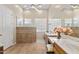 Bright bathroom with dual sinks, tiled floors, and glass block windows for privacy at 42047 N Moss Springs Rd, Anthem, AZ 85086