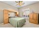 Cozy bedroom featuring carpet, and a wooden headboard with built in drawers and cabinets at 42047 N Moss Springs Rd, Anthem, AZ 85086