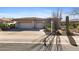 Front exterior view of the home with a wide driveway, desert landscaping and three-car garage at 42047 N Moss Springs Rd, Anthem, AZ 85086