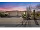 Stunning exterior view of the home showing the three-car garage and desert landscaping at 42047 N Moss Springs Rd, Anthem, AZ 85086