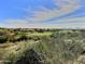 Desert golf course view with lush green grass, mountain backdrop, and scattered homes at 42047 N Moss Springs Rd, Anthem, AZ 85086