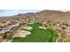 Scenic aerial view of desert golf course featuring lush green fairways and sand traps at 42047 N Moss Springs Rd, Anthem, AZ 85086