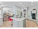 An open kitchen with a breakfast bar, stainless steel appliances, and seamless transition into the living room at 42047 N Moss Springs Rd, Anthem, AZ 85086