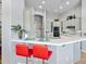 A well-lit kitchen featuring a breakfast bar, stainless steel appliances, and an open design, perfect for entertaining guests at 42047 N Moss Springs Rd, Anthem, AZ 85086