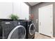 Laundry room with front loading washer and dryer and overhead cabinets at 42047 N Moss Springs Rd, Anthem, AZ 85086