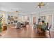 Spacious living room featuring hardwood floors, a fireplace, and large windows, offering a bright and inviting atmosphere at 42047 N Moss Springs Rd, Anthem, AZ 85086