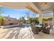 Inviting pool area with rock waterfall feature and covered patio seating at 42047 N Moss Springs Rd, Anthem, AZ 85086