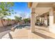 Backyard pool with waterfall feature, desert landscaping and covered patio at 42047 N Moss Springs Rd, Anthem, AZ 85086