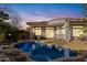 Outdoor pool area at dusk, with nice landscaping around patio and trees at 42047 N Moss Springs Rd, Anthem, AZ 85086