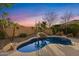 Backyard pool with serene atmosphere and lush desert landscaping at dusk at 42047 N Moss Springs Rd, Anthem, AZ 85086