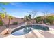 Backyard pool with rock waterfall feature and desert landscaping at 42047 N Moss Springs Rd, Anthem, AZ 85086