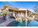 Backyard pool with covered patio and desert landscaping features at 42047 N Moss Springs Rd, Anthem, AZ 85086