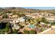 A high-angle of a luxury property showcasing the resort-style pool and luscious backyard in a desert community at 4803 W Buckskin Trl, Phoenix, AZ 85083