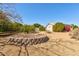 Spacious backyard featuring low-maintenance desert landscaping with trees and shrubs at 4803 W Buckskin Trl, Phoenix, AZ 85083