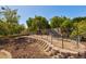 Large backyard with mature fruit trees, terraced gardening and a stone retaining wall at 4803 W Buckskin Trl, Phoenix, AZ 85083