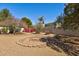 Landscaped backyard area with a stone-lined fire pit, desert plants and rock ground cover at 4803 W Buckskin Trl, Phoenix, AZ 85083