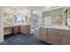 Bathroom featuring dual sinks with marble countertops and stylish hardware with view of exterior at 4803 W Buckskin Trl, Phoenix, AZ 85083