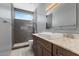 Modern bathroom featuring a glass walk-in shower, large vanity with marble countertop, and decorative lighting at 4803 W Buckskin Trl, Phoenix, AZ 85083