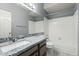 Bathroom with granite counters, white tiled shower and bathtub with gray walls at 4803 W Buckskin Trl, Phoenix, AZ 85083