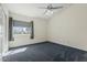 Bedroom featuring carpet, ceiling fan, and a window with blinds providing lots of natural light at 4803 W Buckskin Trl, Phoenix, AZ 85083