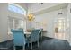 Traditional dining room showcases an elegant chandelier and ample natural light from large windows at 4803 W Buckskin Trl, Phoenix, AZ 85083
