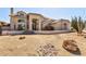 Stunning two-story home featuring desert landscaping, a tile roof, and an arched entry at 4803 W Buckskin Trl, Phoenix, AZ 85083