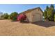 Side view of the property showcasing a well-maintained exterior, desert landscaping and a two-car garage at 4803 W Buckskin Trl, Phoenix, AZ 85083