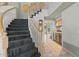 Foyer featuring staircase with carpeted stairs and wood railings at 4803 W Buckskin Trl, Phoenix, AZ 85083