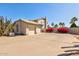Spacious three-car garage with a wide driveway, complemented by mature flowering bushes at 4803 W Buckskin Trl, Phoenix, AZ 85083