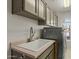 This laundry room features modern appliances, cabinets, and a sink for added convenience at 4803 W Buckskin Trl, Phoenix, AZ 85083