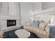 Spacious living room with cozy fireplace and comfortable sofa, perfect for relaxation at 4803 W Buckskin Trl, Phoenix, AZ 85083