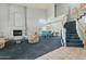 Bright living room with fireplace, staircase, dining area, and an abundance of natural light at 4803 W Buckskin Trl, Phoenix, AZ 85083