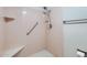 Bathroom featuring a walk-in pink tiled shower with mounted shower head and safety handrail at 482 Leisure World --, Mesa, AZ 85206