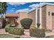 The cozy residence is surrounded by desert landscaping including sculpted bushes and decorative stone at 482 Leisure World --, Mesa, AZ 85206