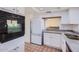 Well-lit kitchen showcases stainless steel sink and white cabinets for ample storage space at 482 Leisure World --, Mesa, AZ 85206