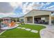 Well manicured backyard has artificial turf, a built in barbeque, and a covered patio at 5189 N 206Th Dr, Buckeye, AZ 85396