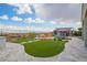 Expansive backyard featuring a built-in fire pit, lush lawn, and an outdoor kitchen at 5189 N 206Th Dr, Buckeye, AZ 85396