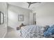 A cozy bedroom with a ceiling fan, framed art, and a calm, neutral color palette at 5189 N 206Th Dr, Buckeye, AZ 85396