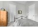 Cozy bedroom featuring neutral walls, carpet, and a black metal bed frame at 5189 N 206Th Dr, Buckeye, AZ 85396