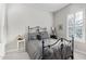 Charming bedroom featuring a wrought iron bed frame, neutral decor, and plantation shutters at 5189 N 206Th Dr, Buckeye, AZ 85396