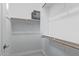 A simple yet functional closet with built-in shelving and hanging rods at 5189 N 206Th Dr, Buckeye, AZ 85396