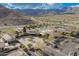 Aerial view of a community clubhouse and pool with mountain views and ample parking at 5189 N 206Th Dr, Buckeye, AZ 85396