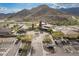Aerial view of a community clubhouse, desert landscaping, and mountain views at 5189 N 206Th Dr, Buckeye, AZ 85396