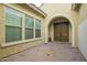 Inviting courtyard leading to a double-door entrance and large windows at 5189 N 206Th Dr, Buckeye, AZ 85396