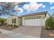 Charming single-story home with a well-manicured lawn and a two-car garage at 5189 N 206Th Dr, Buckeye, AZ 85396