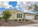 Attractive single-story home with desert landscaping and attached two-car garage at 5189 N 206Th Dr, Buckeye, AZ 85396