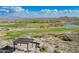 Elevated view of a golf course nestled in a desert community with mountain backdrop at 5189 N 206Th Dr, Buckeye, AZ 85396