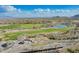 Elevated view of a golf course nestled in a desert community with mountain backdrop at 5189 N 206Th Dr, Buckeye, AZ 85396